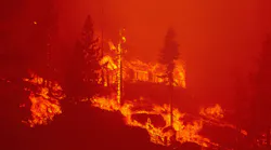 Flames consume a mountain home as the Caldor Fire pushes into South Lake Tahoe, CA, on Aug. 30, 2021.