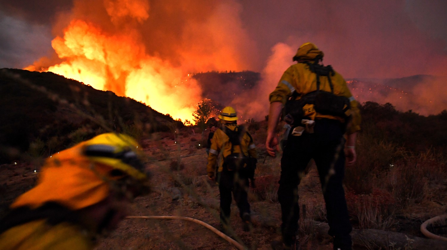 Firefighters make their way up a hill as the El Dorado Fire burns near Yucaipa, CA, in September 2020.