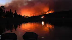 The Caldor Fire reflects off Caples Lake on Sept. 1, 2021 near Lake Tahoe, CA.