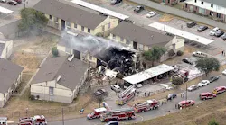A Dallas apartment building smolders after a gas explosion tore through the building on Wednesday Sept. 29, 2021.