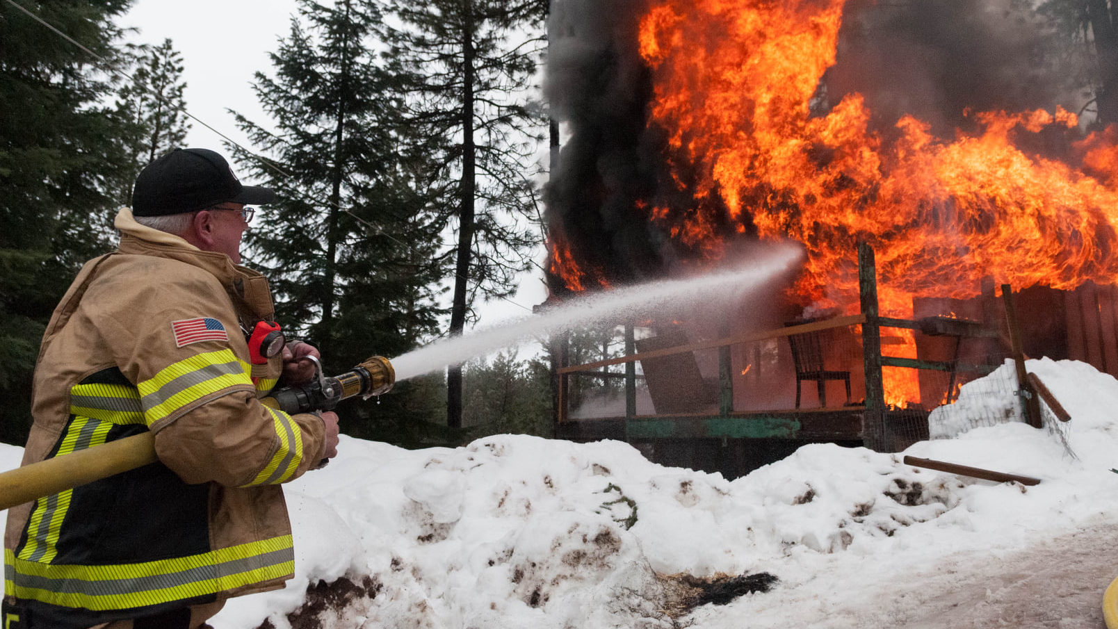 Garden Valley Fire District Chief Jon Delvalle pours water on a fire in this undated photo posted by the department.
