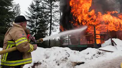 Garden Valley Fire District Chief Jon Delvalle pours water on a fire in this undated photo posted by the department.