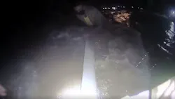 Body camera footage shows a woman clinging to a roadway guardrail in waist-high swiftwaters as a Ewing police officer rescues her during Tropical Storm Ida.