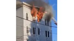 A fire burns on the sixth floor of an apartment building in Lewiston, ME, where a 70-year-old man leaped to escape the flames and died on Sept. 11, 2021.