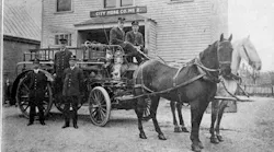 The Lexington Hose and Chemical Company Station #2 is pictured in the background of this 1898 photo of firefighters and a horse-drawn fire apparatus.