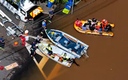 Emergency personnel use a boat to rescue people stranded in a flooded section of Manville Thursday. Emergency personnel use a boat to rescue people stranded in a flooded section of Manville Thursday.