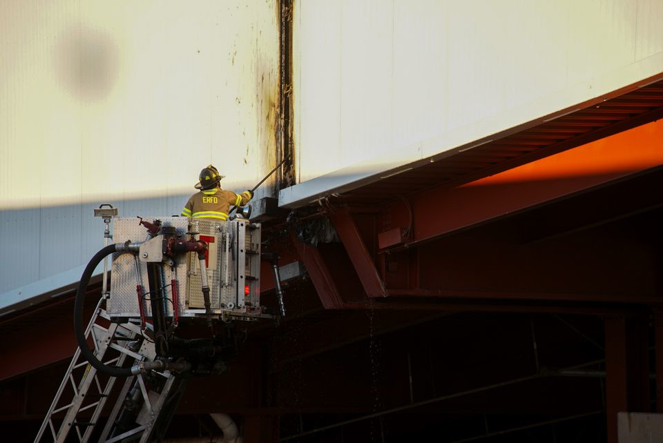 An East Rutherford firefighter works to open up around the fire at the American Dream Mall.