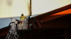 An East Rutherford firefighter works to open up around the fire at the American Dream Mall.