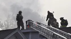 Springfield, MA, firefighters at work on on the roof of a burning home on Friday, Oct. 15, 2021.