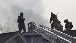 Springfield, MA, firefighters at work on on the roof of a burning home on Friday, Oct. 15, 2021.