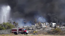 Firefighters work to extinguish a fire at a junk yard in Otay Mesa on Saturday.