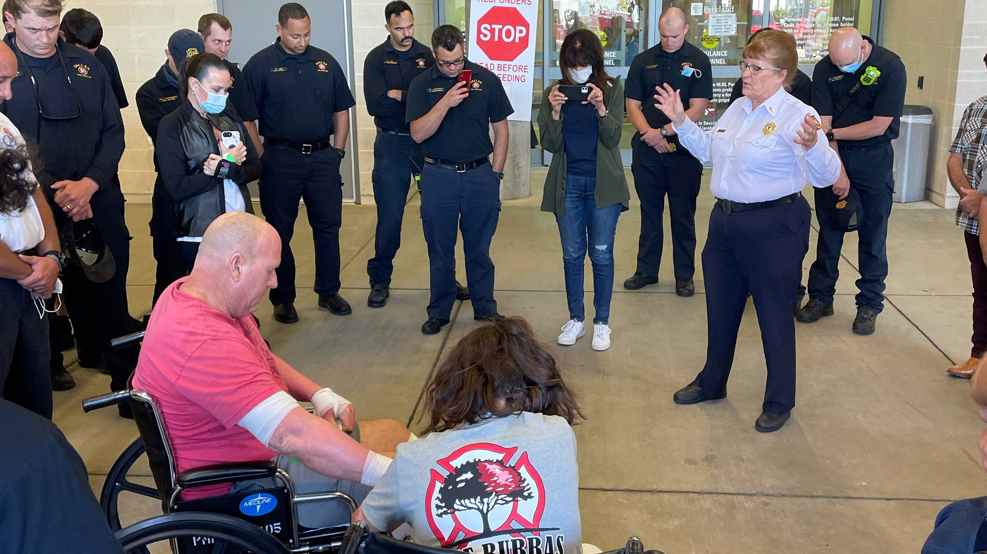 Capt. Christopher Gadomski and Fire Rescue Officer Pauline Perez hold hands during a prayer after Perez was released from the burn center two weeks after she was injured in an explosion.