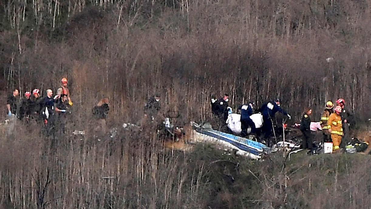 Responders remove a body from the wreckage of a helicopter crash that killed NBA star Kobe Bryant, his daughter Gianna and seven others in Calabasas, CA, on Jan. 26, 2020.