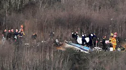 Responders remove a body from the wreckage of a helicopter crash that killed NBA star Kobe Bryant, his daughter Gianna and seven others in Calabasas, CA, on Jan. 26, 2020.