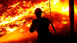 A firefighter battles the Alisal Fire along the 101 Freeway near Goleta, CA, on Tuesday, Oct. 12, 2021. A firefighter battles the Alisal Fire along the 101 Freeway near Goleta, CA, on Tuesday, Oct. 12, 2021.