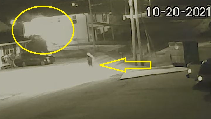 In this screen capture from security camera footage, a person wearing a hoodie can be seen running from a burning building in Fort Oglethorpe, GA, on Wednesday, Oct. 20, 2021.