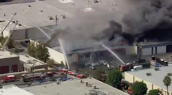 A warehouse containing a suspected marijuana grow burns in the Canoga Park section of Los Angeles on Monday, Oct. 18, 2021.