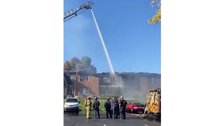 Crews pour water on a burning apartment complex in Dayton, OH, on Monday, Oct. 18, 2021.
