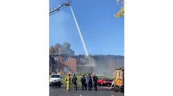Crews pour water on a burning apartment complex in Dayton, OH, on Monday, Oct. 18, 2021.