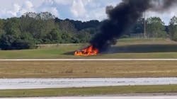 A small plane burns after crashing in a field next to a runway at DeKalb-Peachtree airport in Chamblee, GA, on Friday Oct. 8, 2021.