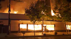 Fire consumes an abandoned commercial building in San Diego, CA, on Tuesday, Oct. 19, 2021.