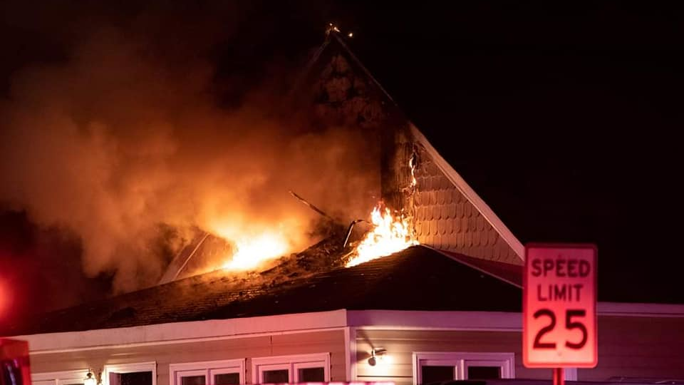Fire burns on the upper floor and lower roof area of an Edgewater, MD, home on Wednesday, Oct. 20, 2021.