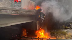 A burning semi truck hangs off the side of a bridge in Floriston, CA, after a crash on Sunday, Oct. 24, 2021.