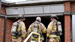 Greensboro firefighters stand outside an entrance to a vacant elementary school while battling a third-alarm fire on Thursday, Oct. 7, 2021. Greensboro firefighters stand outside an entrance to a vacant elementary school while battling a third-alarm fire on Thursday, Oct. 7, 2021.
