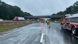 A Tolland firefighter hoses down I-84 after a semi-trailer hauling gypsum powder struck an overpass on Oct. 4, 2021. A Tolland firefighter hoses down I-84 after a semi-trailer hauling gypsum powder struck an overpass on Oct. 4, 2021.