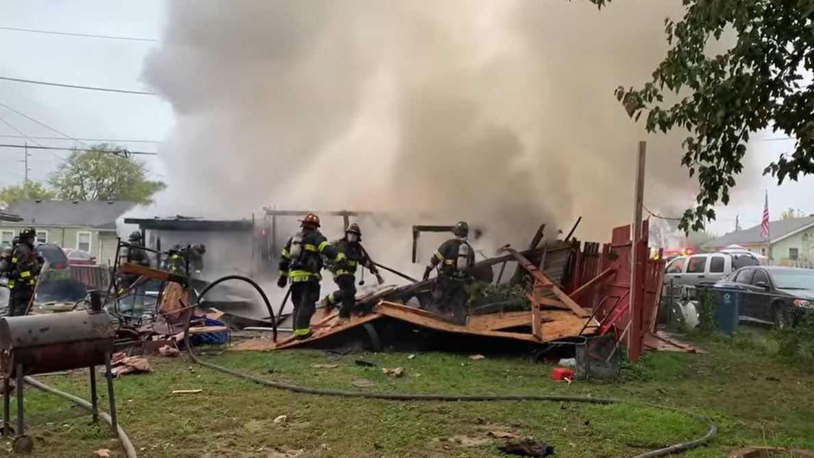 Wayne Township firefighters at work amid the smoky remains of a home that exploded in Indianapolis on Friday, Oct. 22, 2021.