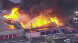 A Volkswagen dealership burns in a massive multi-alarm fire in Linden, NJ, on Friday, Oct. 29, 2021.