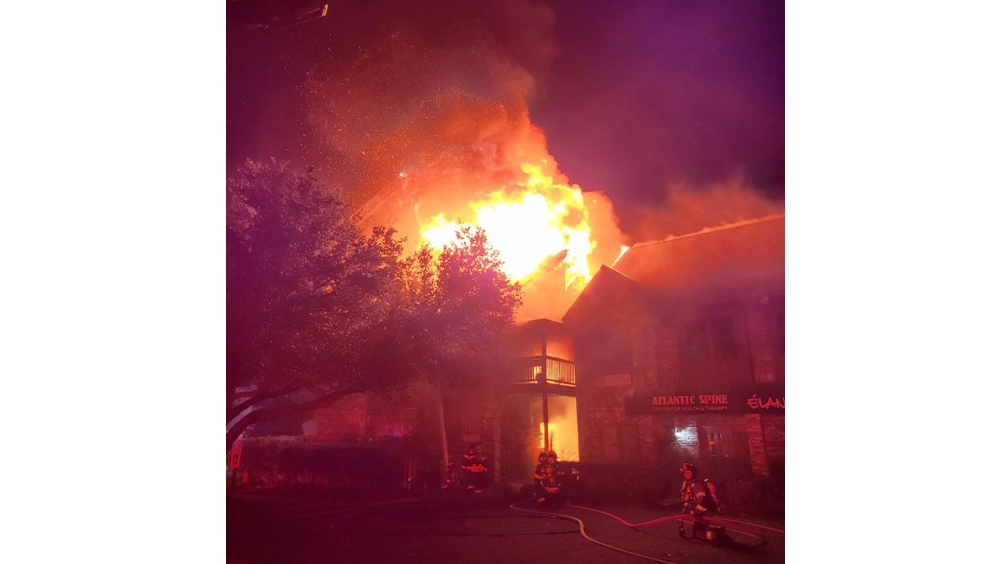 Firefighters work to extinguish a commercial fire in Myrtle Beach, SC, on Tuesday, Oct. 26, 2021.