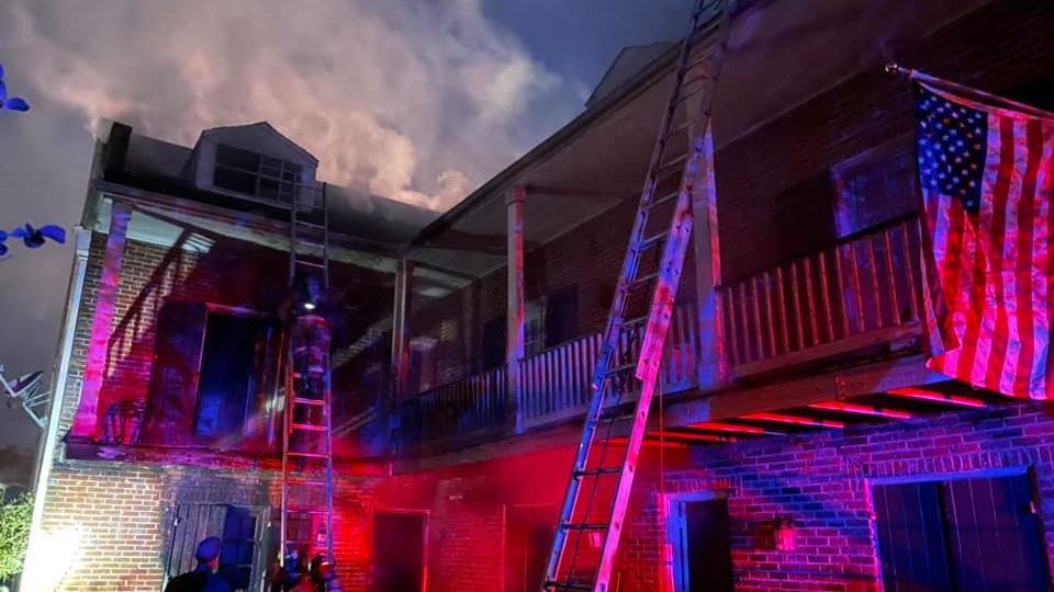 A burning residence in the Uptown section of New Orleans where firefighters rescued a man from the roof on Friday, Oct. 15, 2021.