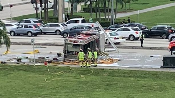 A Palm Beach County apparatus sits on its side after flipping in a collision with a pickup truck in Boca Raton, FL, on Saturday, Oct. 23, 2021.