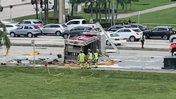 A Palm Beach County apparatus sits on its side after flipping in a collision with a pickup truck in Boca Raton, FL, on Saturday, Oct. 23, 2021.