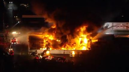 An auto auction warehouse burns during a four-alarm fire in Pennsauken, NJ, on Tuesday, Oct. 26, 2021.
