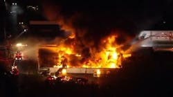 An auto auction warehouse burns during a four-alarm fire in Pennsauken, NJ, on Tuesday, Oct. 26, 2021.