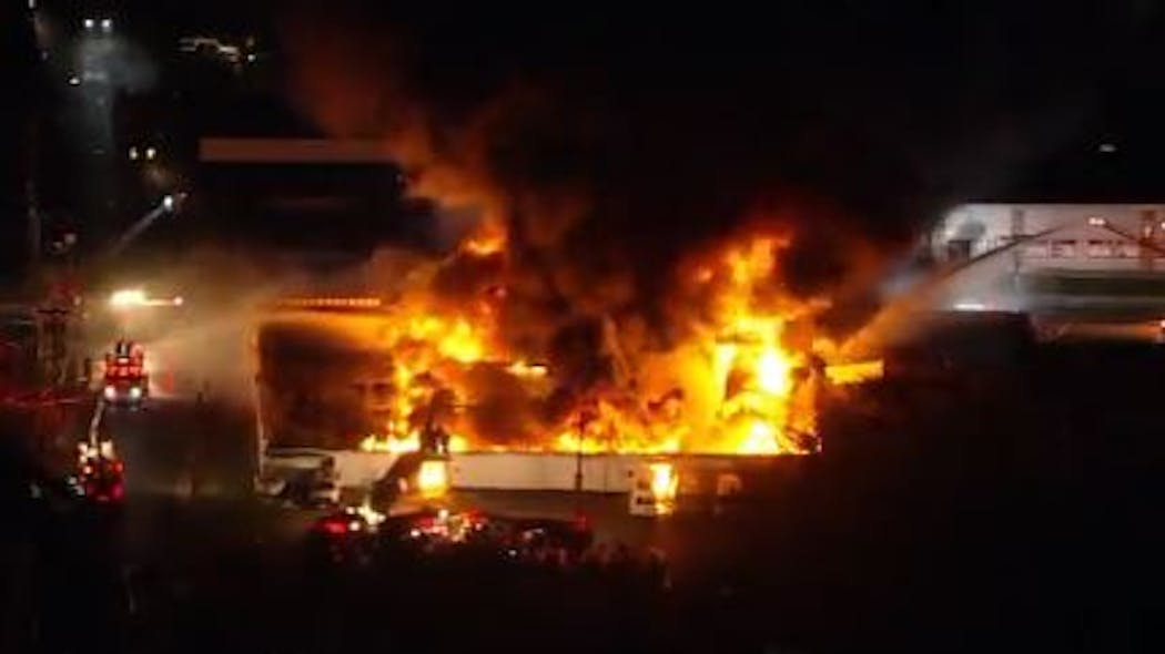 An auto auction warehouse burns during a four-alarm fire in Pennsauken, NJ, on Tuesday, Oct. 26, 2021.