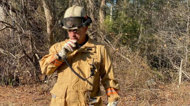Deputy Chief Eric Germain radios in a progress report at a brush fire in Carver, MA, in this undated photo.