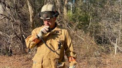 Deputy Chief Eric Germain radios in a progress report at a brush fire in Carver, MA, in this undated photo.