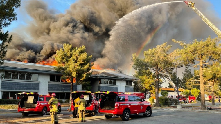 Firefighters battle a massive fire at an office complex in San Bernardino, CA, on Sunday Oct. 3, 2021.