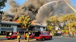 Firefighters battle a massive fire at an office complex in San Bernardino, CA, on Sunday Oct. 3, 2021.