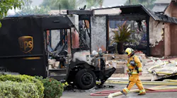 A burned-out UPS delivery truck sits in front of a smoldering home after a plane crash in Santee, CA, that killed two people, including the UPS driver, on Monday, Oct. 11, 2021.