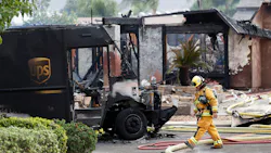 A burned-out UPS delivery truck sits in front of a smoldering home after a plane crash in Santee, CA, that killed two people, including the UPS driver, on Monday, Oct. 11, 2021.