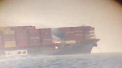Flames can be seen among shipping containers on a cargo vessel sitting about 5 miles off the coast of British Columbia on Saturday, Oct. 24, 2021. Flames can be seen among shipping containers on a cargo vessel sitting about 5 miles off the coast of British Columbia on Saturday, Oct. 24, 2021.