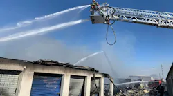 Firefighters work to extinguish a fire that tore through two buildings containing storage units in Owensboro, KY, on Thursday, Oct. 21, 2021.