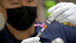 An LAFD paramedic prepares a dose of the Moderna COVID-19 vaccine for a firefighter in December 2020. An LAFD paramedic prepares a dose of the Moderna COVID-19 vaccine for a firefighter in December 2020.