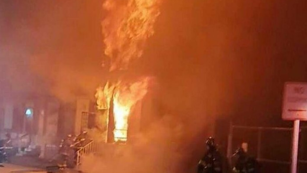 Baltimore firefighters arrive to find heavy fire showing on both floors of a two-story row house on Monday, Nov. 15, 2021.