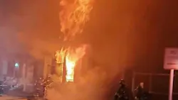 Baltimore firefighters arrive to find heavy fire showing on both floors of a two-story row house on Monday, Nov. 15, 2021.