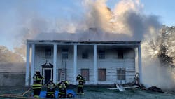 Bloomington firefighters mask up during a live fire training evolution. Bloomington firefighters mask up during a live fire training evolution.